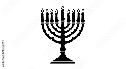 A vintage golden Hanukkah menorah with burning candles stands as an antique metal decoration featuring elegant cups and a warm flame light isolated against a plain background