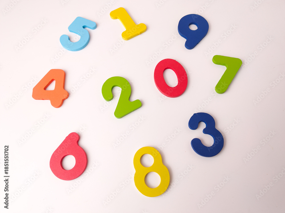 Fototapeta premium Colorful wooden or foam number manipulatives, likely part of a puzzle or learning set