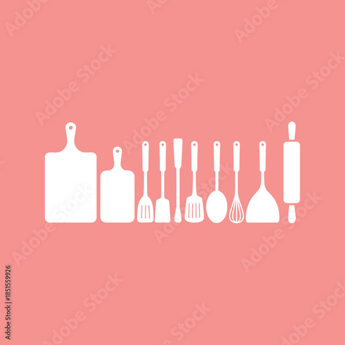 Collection of essential white kitchen utensils and cooking tools on a soft pink background