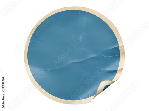 A blank blue circular sticker with a vintage look, featuring a peeled corner and wrinkled texture on a white background.