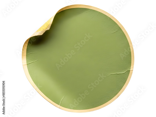 A circular green sticker with a peeled corner and wrinkled texture, isolated on a white background.