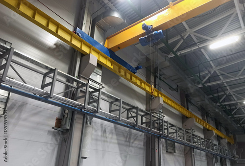 A crane beam at a factory for lifting heavy objects in a workshop.