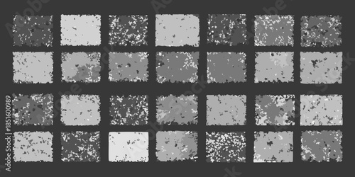 Abstract arrangement of textured grayscale squares in a grid pattern