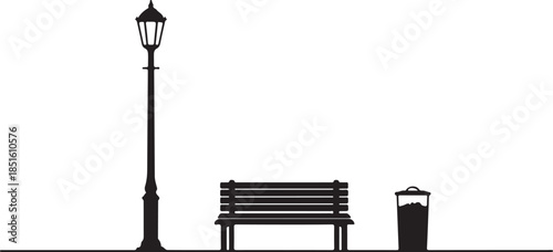 Silhouette of a vintage wooden bench and an antique iron lamppost standing as elegant furniture objects against a city park sky under the glow of an old street lantern