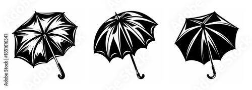 Three open umbrellas in a row classic black and white design for weather protection and style