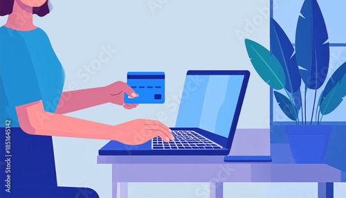 Person holding a card typing on laptop at desk, near indoor plant