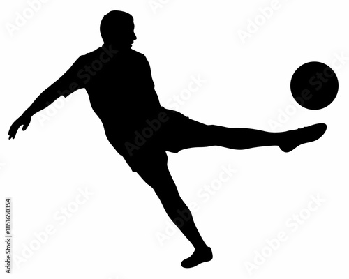 A silhouette of a person kicking a soccer ball in motion