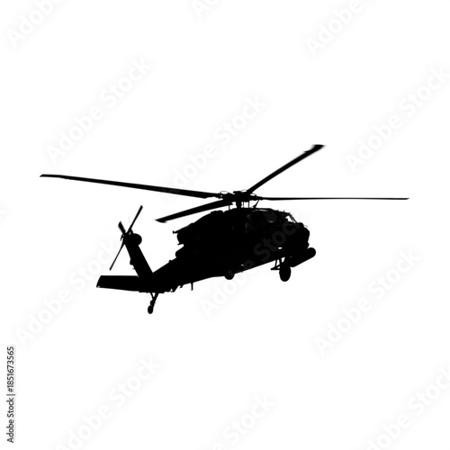 Silhouette of a military helicopter flying in the air
