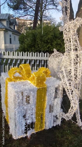 Reindeer with gift box white yellow bent light sparkling blinking Christmas day street joy celebrations