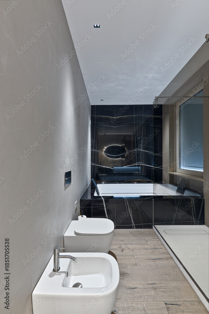 custom made wallpaper toronto digitalClose-up of white porcelain bidet and toilet in a modern domestic bathroom. Background shows a large bathtub. Hardwood flooring and bright lighting.