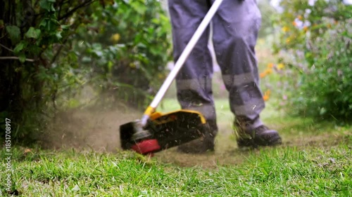 Man with trimmer in garden plot