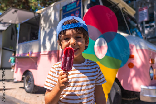 Photos Happy child eating popsicle in front of food truck in vancouver