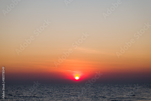 sunrise over the ocean on a smokey morning