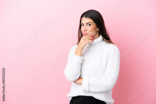 Young Italian woman isolated on pink background thinking