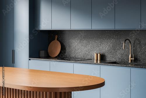 Fotografía Modern kitchen interior with matte blue cabinets, wooden island, and textured stone backsplash in elegant minimalist design