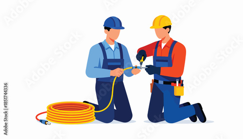 Two technicians kneels, connecting cable with tools, coiled cable nearby