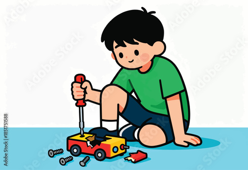Boy fixing a broken toy car with a screwdriver and screws