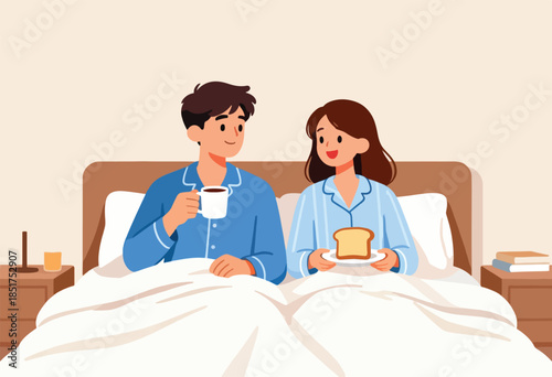 Couple in bed enjoying breakfast and coffee