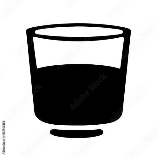 A glass filled with dark liquid