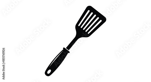 A black kitchen utensil a flat spatula presented as a striking silhouette