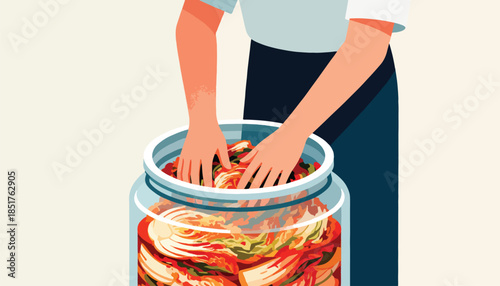 Hands pack vibrant fermented cabbage into a large glass jar