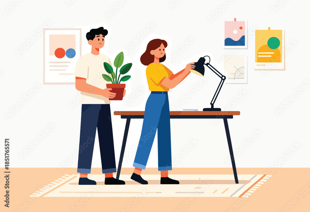 Fototapeta premium Two people arranging a desk with a lamp and plant, with artwork on the wall