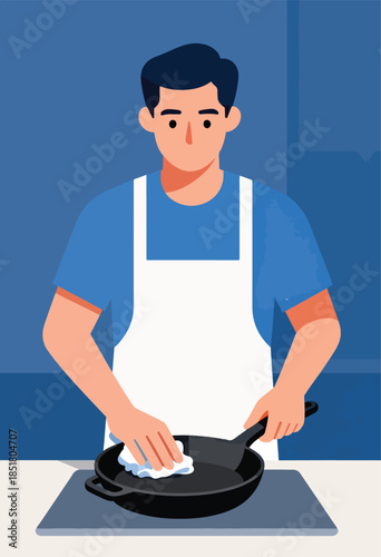 Person in apron cleaning cast iron pan with cloth