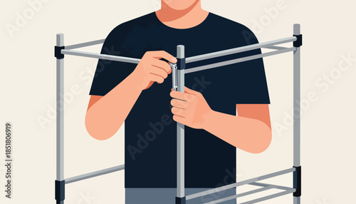 Person assembling a modular metal frame with tools