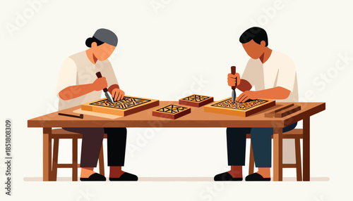 Two people carving wood blocks with intricate designs at a wooden table