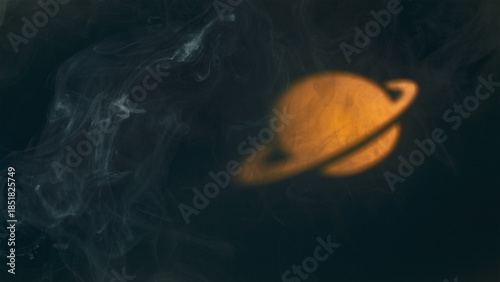 Glowing planet Saturn in smoke, abstract space background