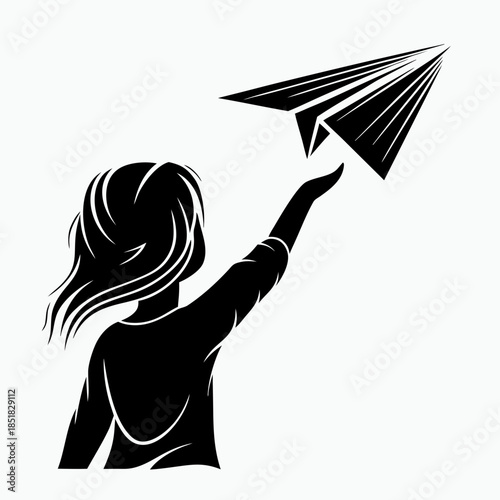 Young woman launching paper airplane with joy and enthusiasm  