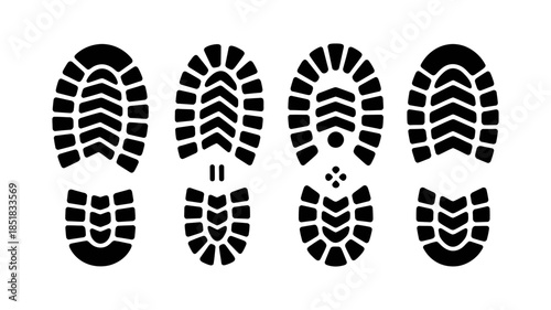 A set of four distinct black boot print silhouettes