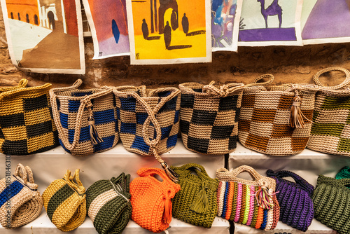 Colorful Woven Baskets Displayed Along A Wall With Art Prints In An Artisan Market, Marrakesh, Morocco