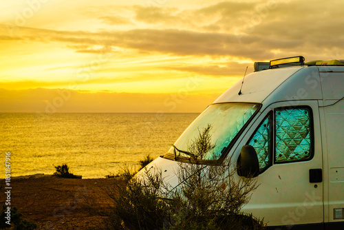 Campervan on beach at sunrise