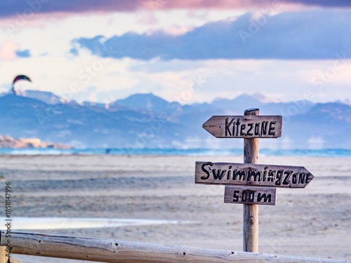 Kitezone and swimmingzone sign at beach.