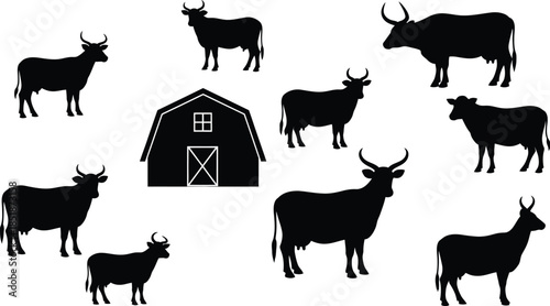 Silhouette of a herd of deer and a barn