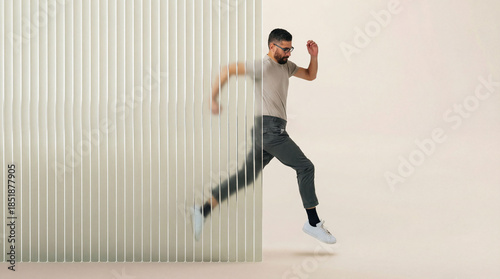 Man in motion breaking through 3D fluted glass barrier