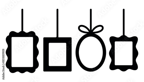 Four black silhouette frames of various shapes hanging on white background