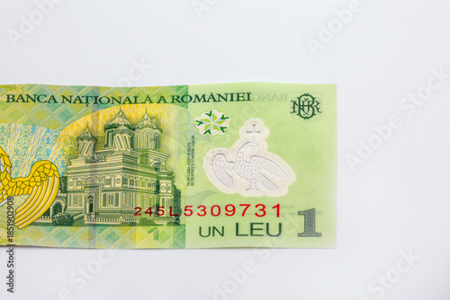 Romanian one leu banknote with architectural detail closeup on white.