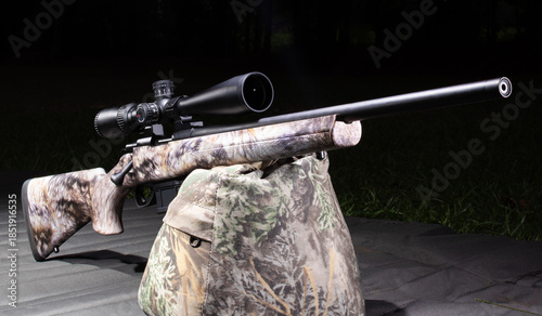 Bolt action rifle at a dark outdoor range