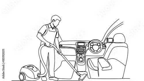 Man vacuuming car interior with cleaning equipment