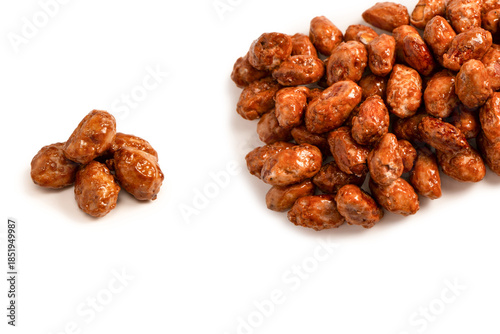 Tasty sweet roasted peanuts isolated on a white background.