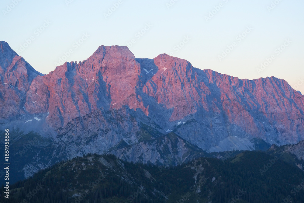 Fototapeta premium Spectacular sunset over the Karwendel mountains, with glowing peaks and dramatic alpine light.