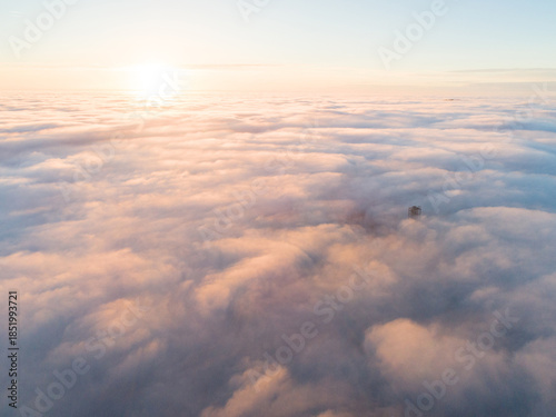 Golden sunset over Velka Homola, lookout tower rising from a sea of clouds. Little Carpathians, Slovakia
