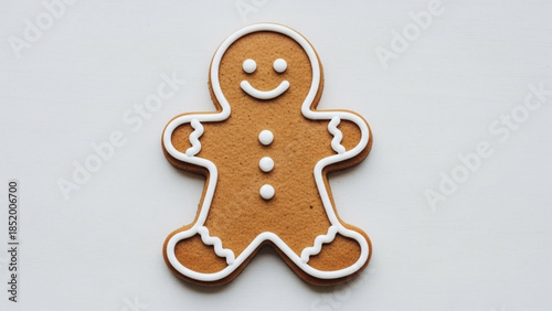 Delicious gingerbread man cookie with white icing details on a plain background perfect for holiday baking and festive treats