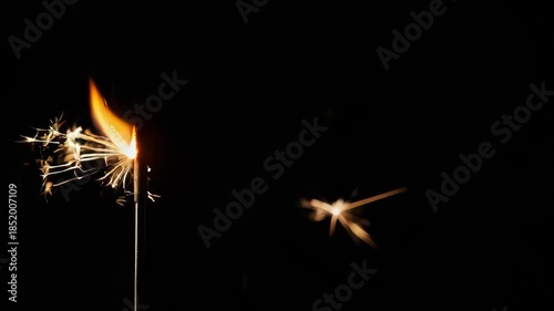 Sparklers lit in the dark night.