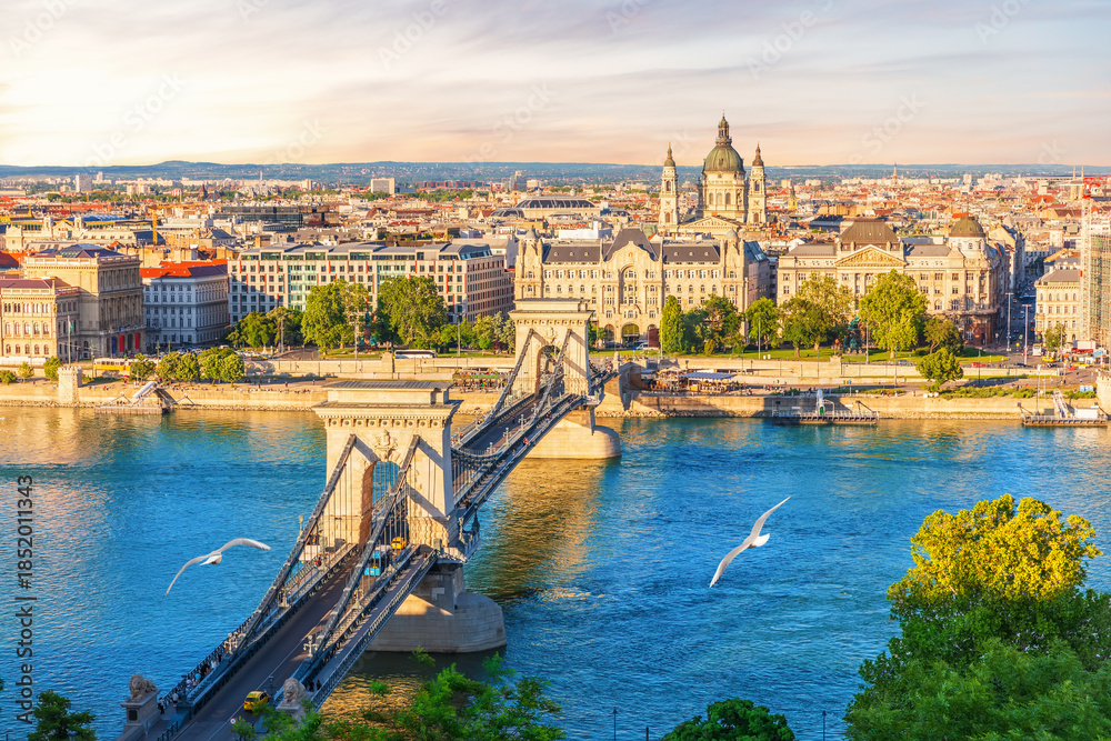 Fototapeta premium Skyline panorama of Budapest Chain Bridge over blue Danube with St. Stephen's basilica view, Hungary