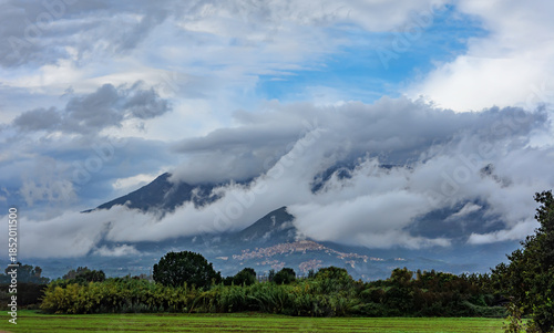 Mountains covered by clouds see from the plain, after the rain.