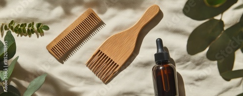 Natural Wooden Hair Tools with Oil on Soft Fabric Background