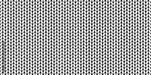 Close up of a monochrome knit fabric texture with a repeating pattern